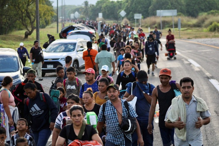 移民大篷车成员在前往埃尔帕索的途中紧紧抓住野兽火车